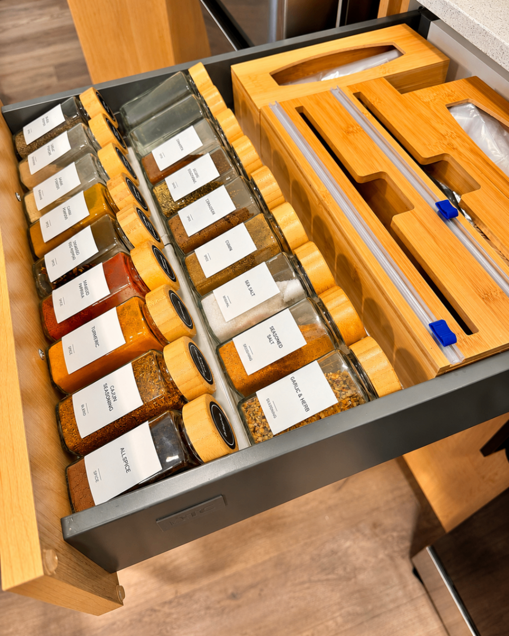 Narrow drawer with spices organized in rows.